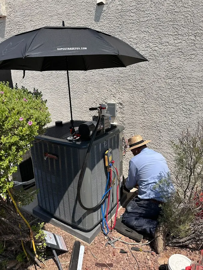 HVAC technician performing outdoor AC maintenance in Heber